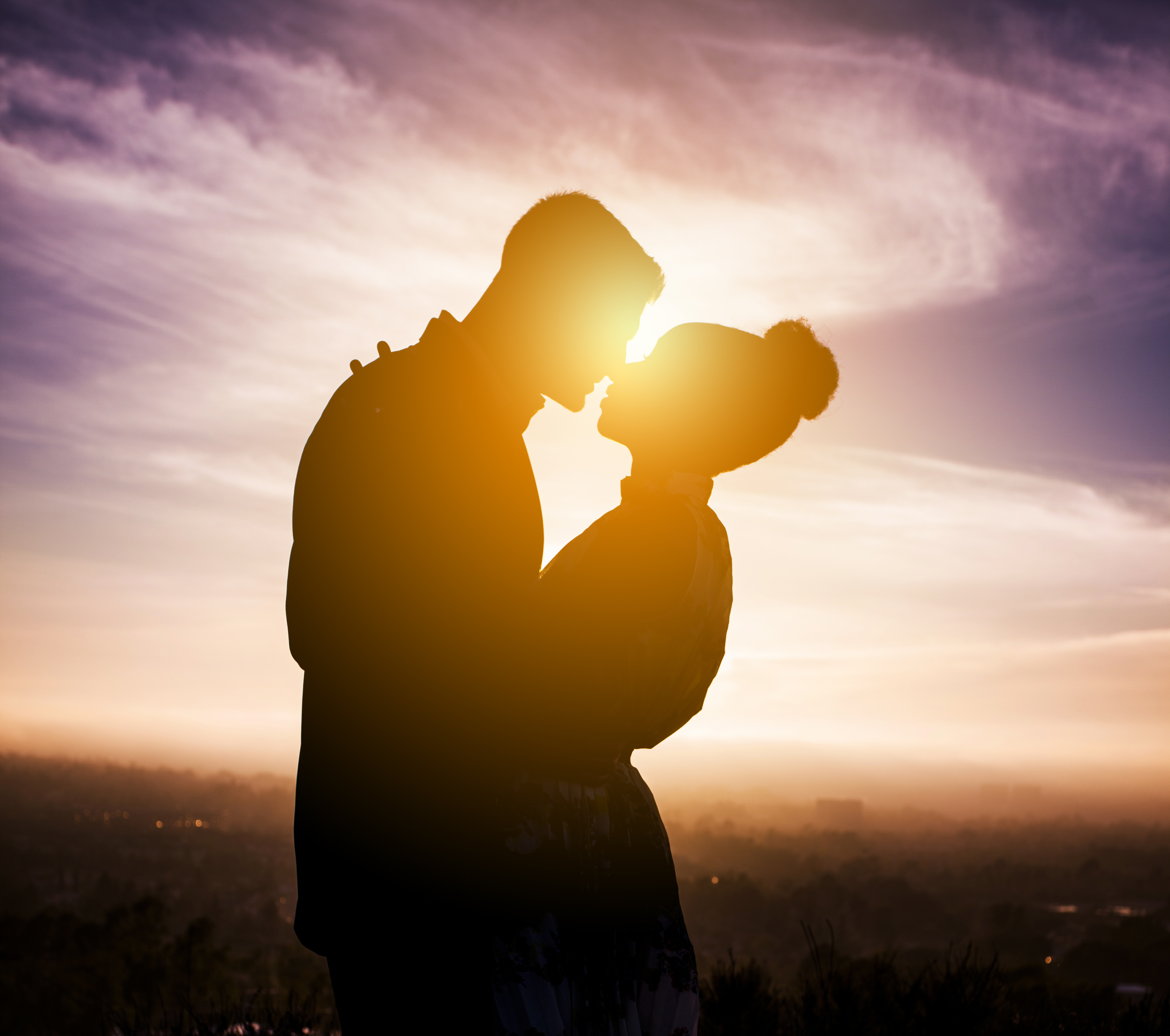 Diverse Couple Engagement Silhouettes at Sunset
