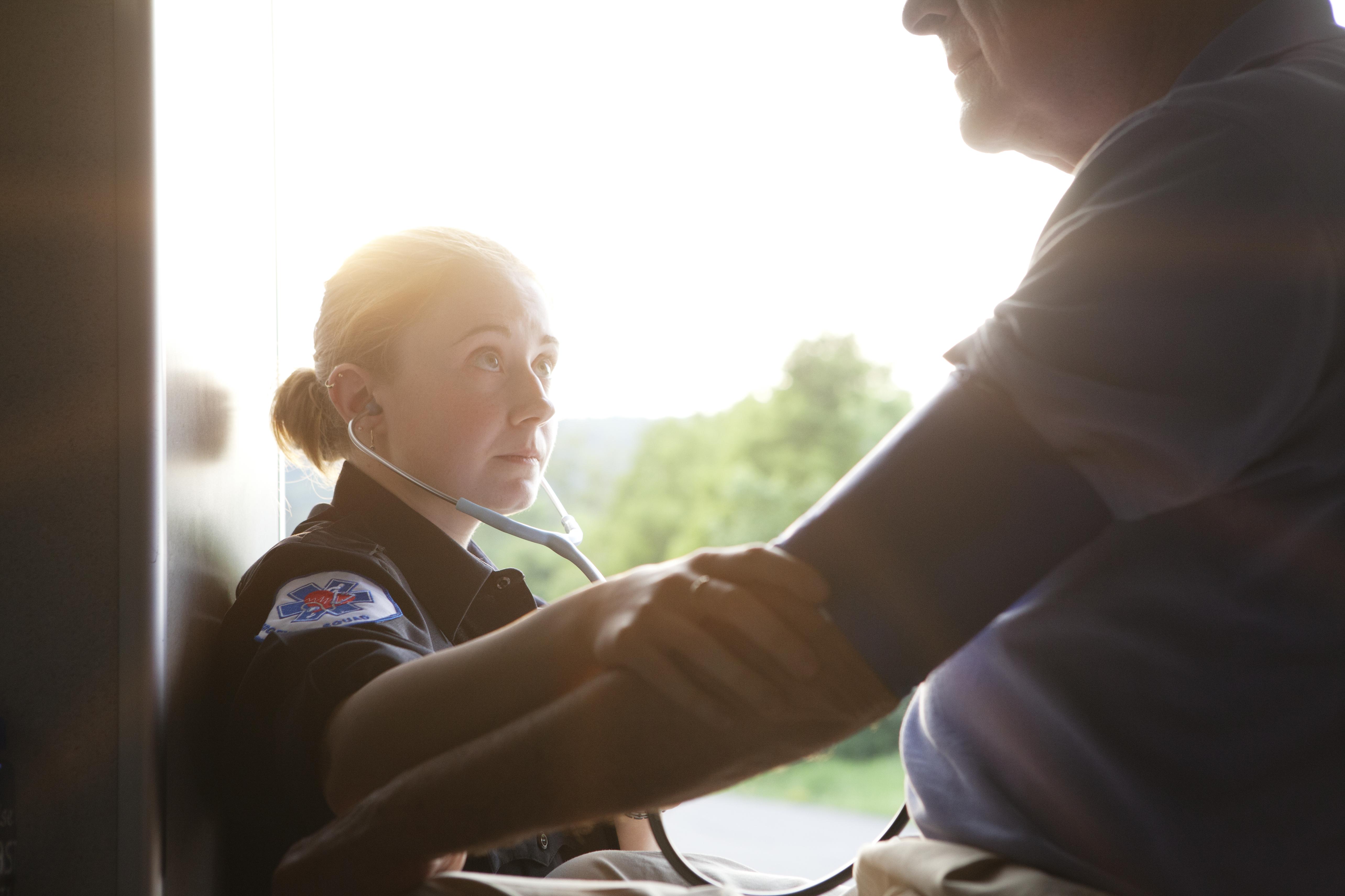 EMT Checking Blood Pressure of Senior Man