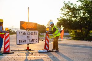 Hispanic Workers Setting Barriers and Directing Traffic Street Road and Highway Construction Photo Series