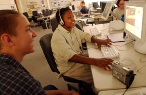 DENVER, CO, JUN 19, 2003 - Isaac Anthony , 16 , of Denver North High school , left, helps Jasser Mohamed , 13 , of Hamilton Middle school, edit his movie during Digital Currents Summer Program at Denver North High School