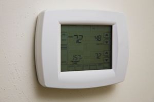 Home thermostat hanging on wall