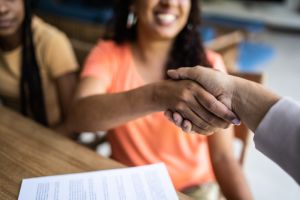 Professional consultant handshake with customer during a home visit