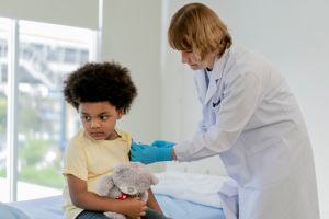 Little boy feeling pain while getting a vaccine