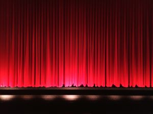 Red Closed Curtains On Stage