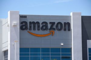 An Amazon logo is displayed on a fulfillment center...
