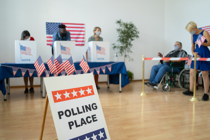 People voting and waiting to vote at a polling station