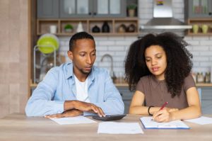 Worried young couple doing their accounts