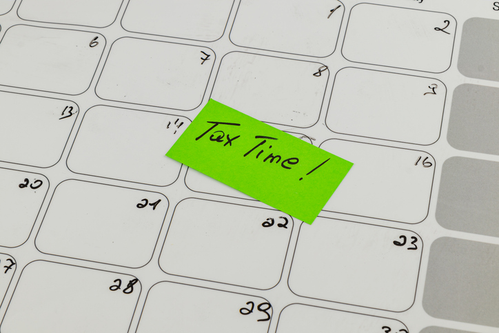 Reminder for important tax deadlines on a whiteboard calendar