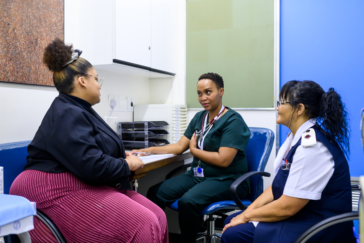 Women discussing breast cancer consultation in a professional healthcare setting