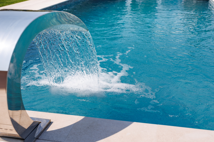 Modern Luxury Pool with Waterfall Feature and Clear Blue Water for Outdoor Relaxation